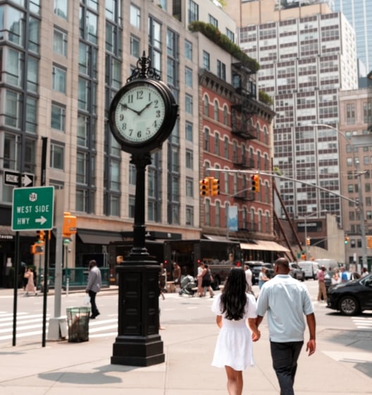 A couple strolling down a Tribeca in NY, hand in hand, enjoying each other's company and the urban scenery.